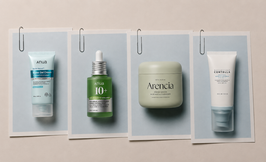 Four skincare products displayed on light blue paper sheets with silver paper clips, arranged horizontally with slight tilts and overlapping layers against a soft beige background.