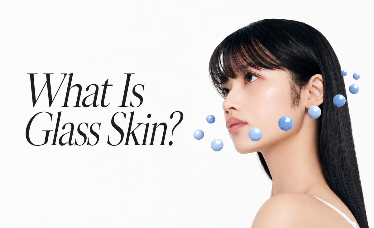 Glass skin skincare banner featuring a woman with radiant, dewy skin, surrounded by glossy blue spheres, with the headline 'What Is Glass Skin?' on a clean white background.