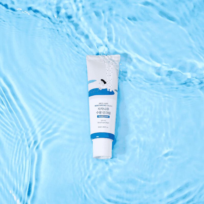 Tube of Round Lab Birch Juice Moisturizing Sunscreen on a blue water background