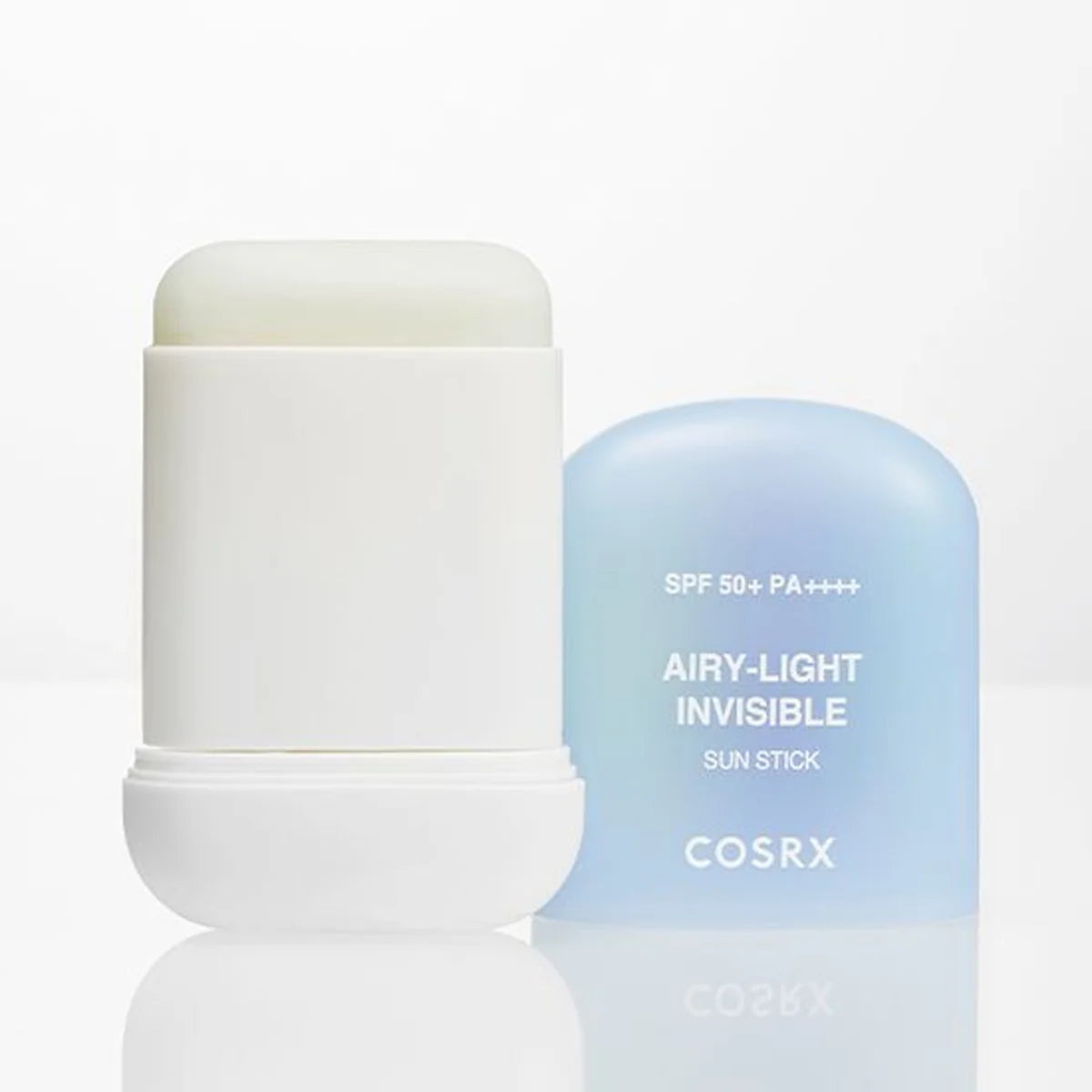 COSRX Airy-Light Invisible Sun Stick 19g Showing the white stick container with the cap removed next to its light blue translucent cap on a reflective white surface.