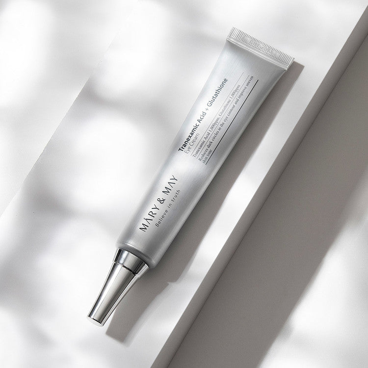 Mary&May Tranexamic Acid + Glutathione Eye Cream on a gray background