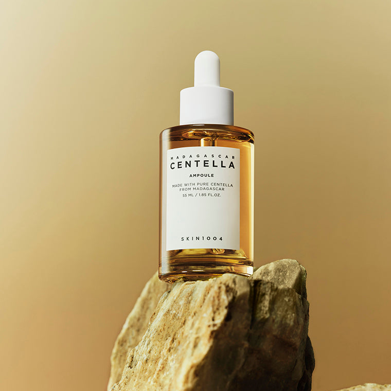 SKIN1004 Madagascar Centella Ampoule on a samll rock with gold background