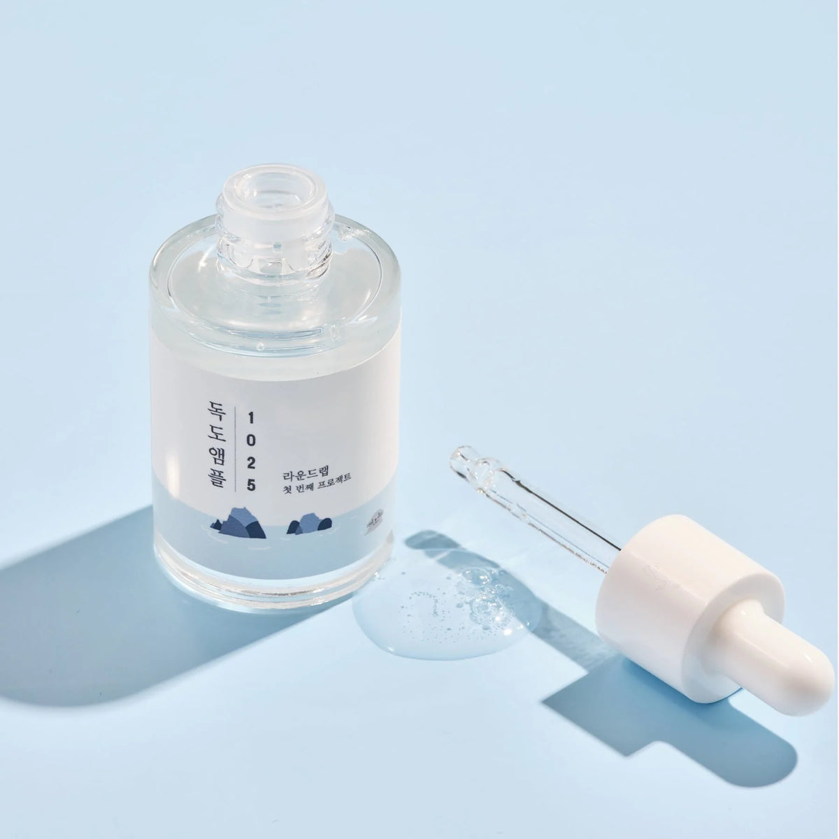 Round Lab 1025 Dokdo Ampoule on a light blue background