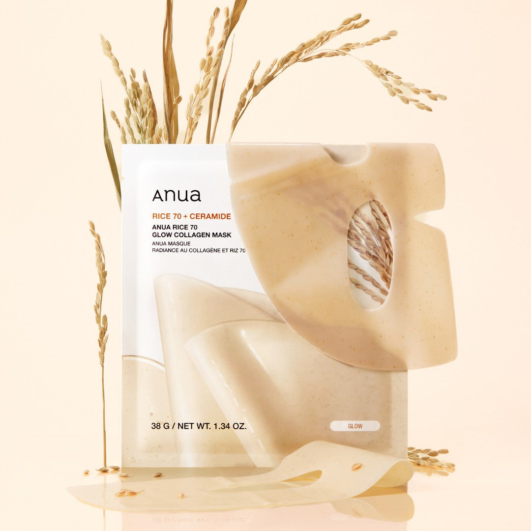 Anua Rice 70 + Ceramide Glow Collagen Mask in a beige pouch, styled with dried rice stalks on a warm cream background.