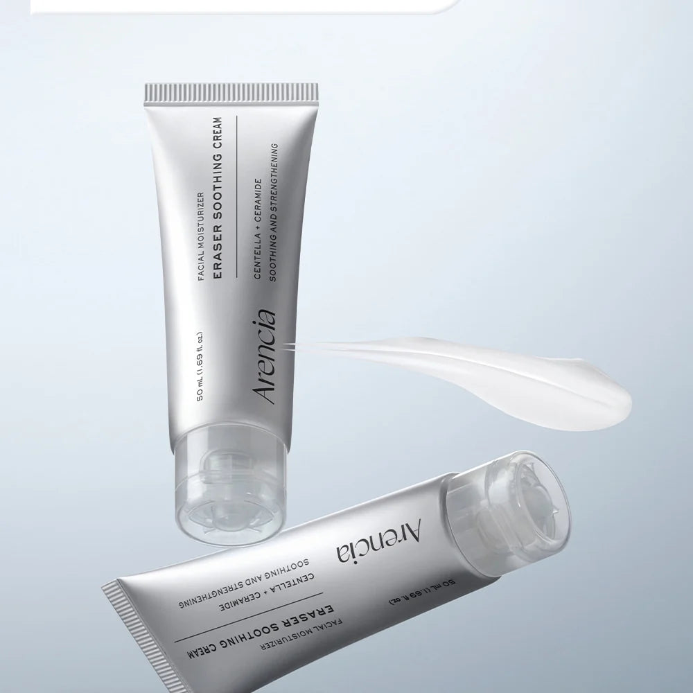 Two silver Tube of Arenicia Eraser Soothing Cream on a pale blue background, one upright and one horizontal, with a white cream smear shown between them.