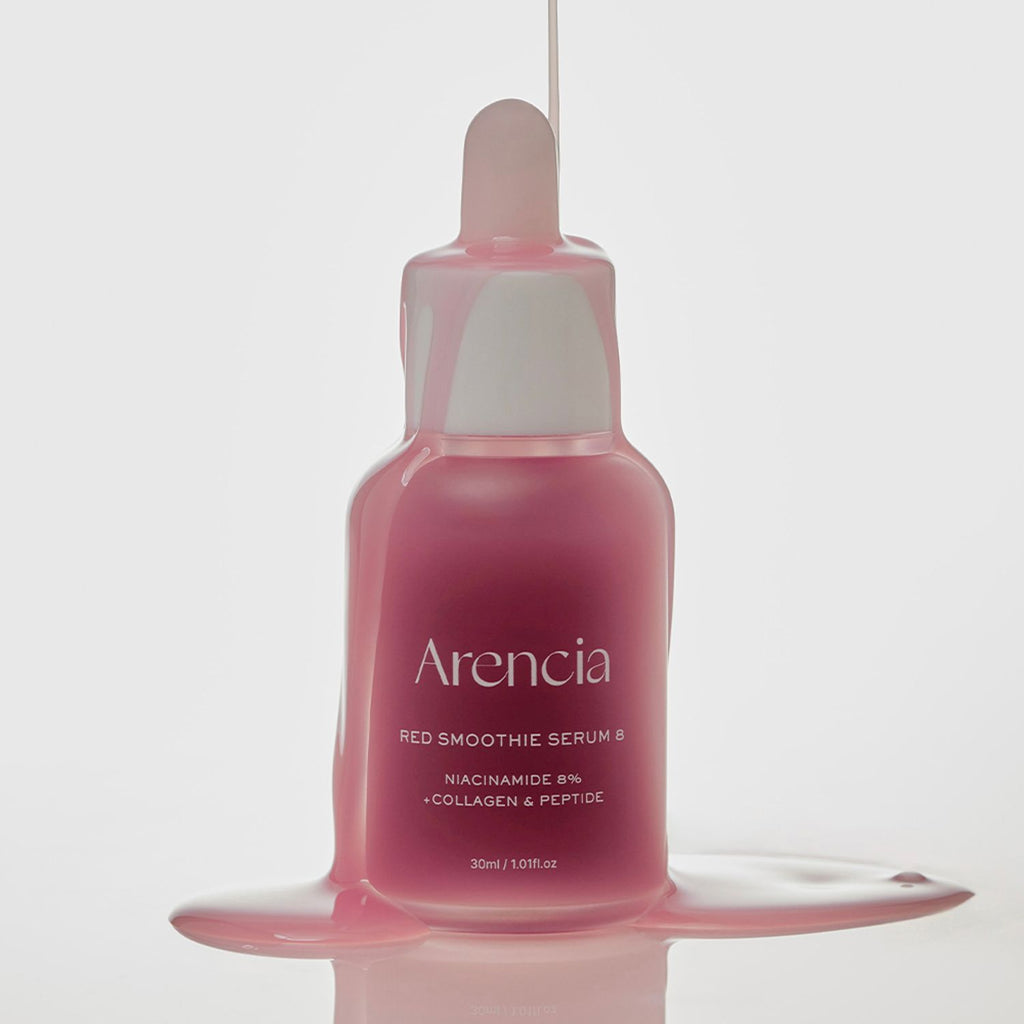 A 30ml dropper bottle of Arencia Red Smoothie Serum 8, filled with a pink liquid and shown with the liquid dripping from the top and pooling at the base against a clean white background.