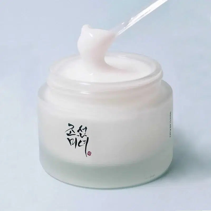 Beauty Of Joseon Dynasty Cream jar with a spoonful of cream on a light blue background