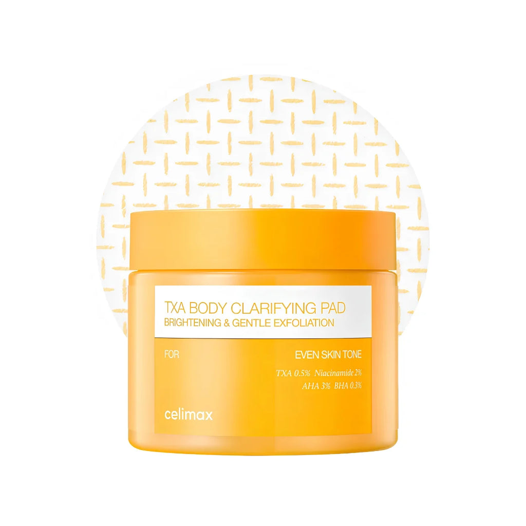 A jar of celimax TxA Body Clarifying Pad in a bright orange-yellow color, featuring a white label with gold text, set against a white background with a subtle gold geometric pattern.