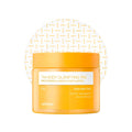 A jar of celimax TxA Body Clarifying Pad in a bright orange-yellow color, featuring a white label with gold text, set against a white background with a subtle gold geometric pattern.
