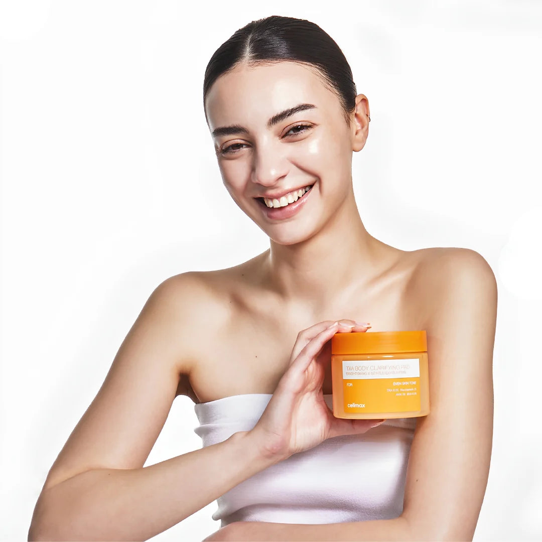 A smiling woman with Celimax TXA Body Clarifying Pad against a clean white background.