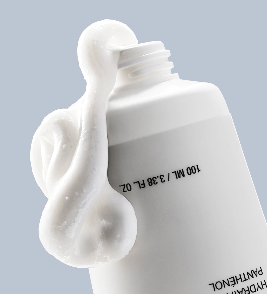 Anua 3 Ceramide Panthenol Moisture Barrier Cream 100ml with a stream of white liquid on a light gray background