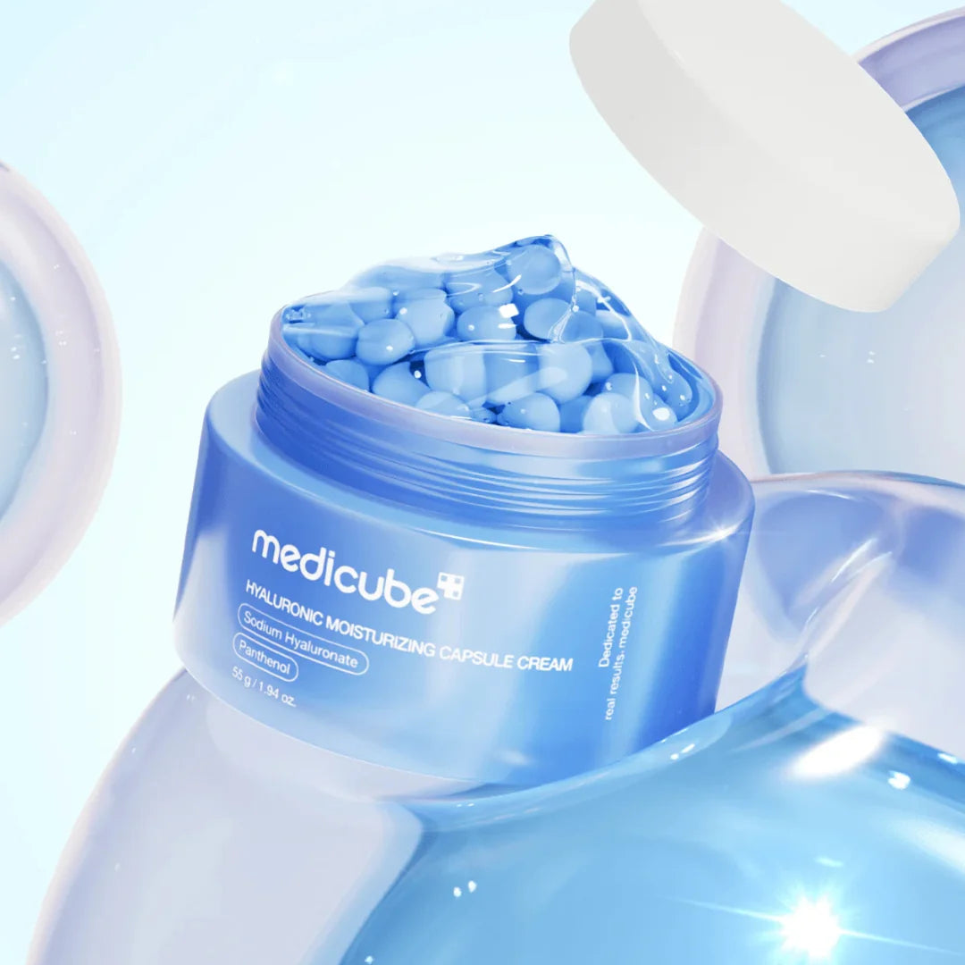 Blue jar of Medicube Hyaluronic Moisturizing Capsule Cream with capsules on a light blue background