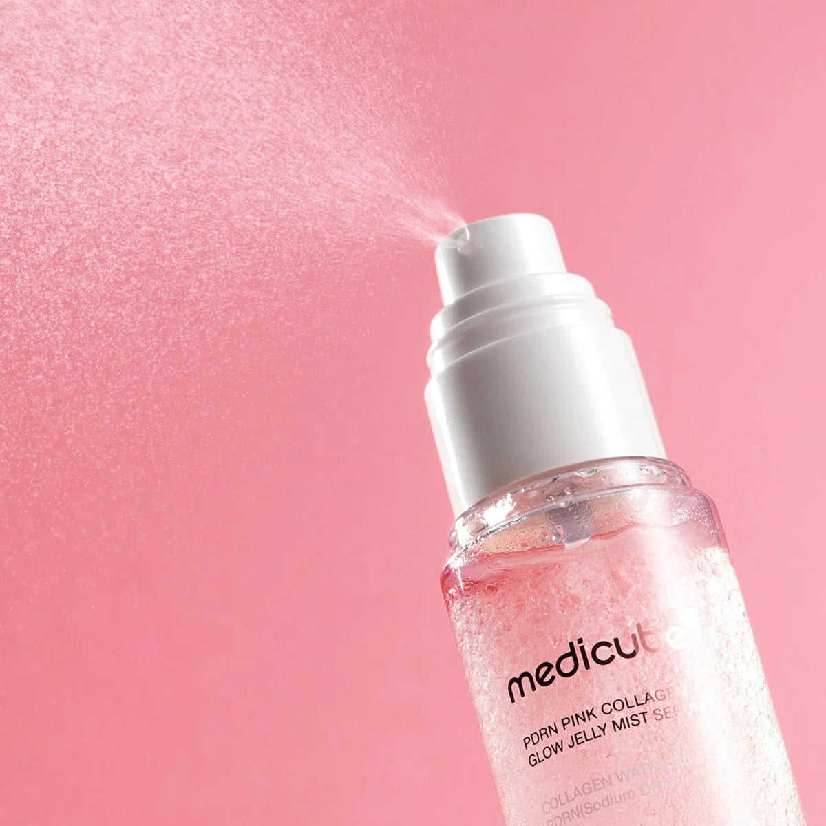 Medicube PDRN Pink Collagen Glow Jelly Mist Serum on a pink background