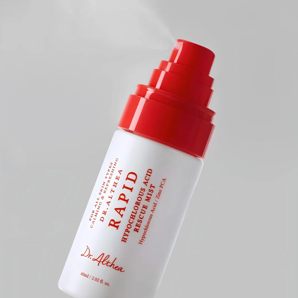Dr. Althea Rapid Hypochlorous Acid Rescue Mist bottle with a white body and bright red pump dispenser, shown spraying against a light gray background.