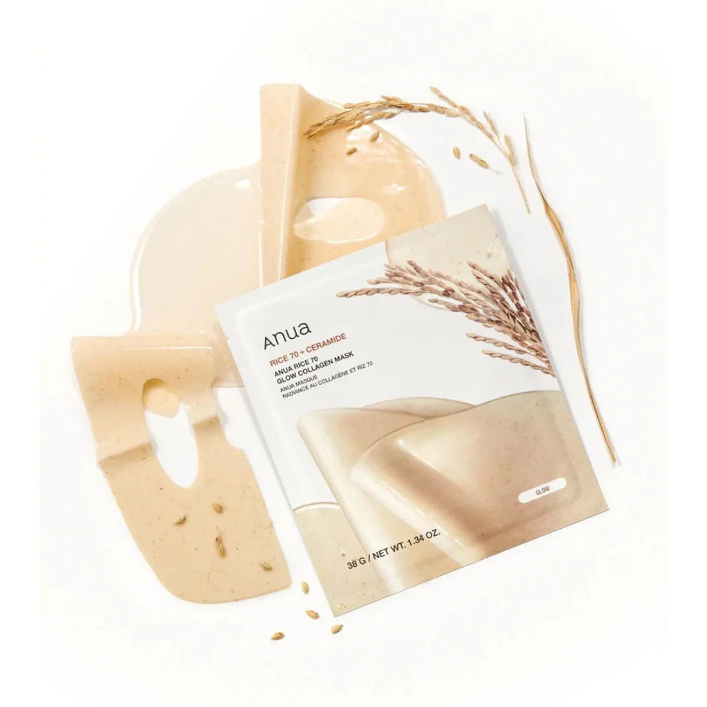 Anua Rice 70 + Ceramide Glow Collagen Mask packaging shown with a beige mask sheet and a beige mask gel pool on a clean white background, styled with dried wheat stalks.