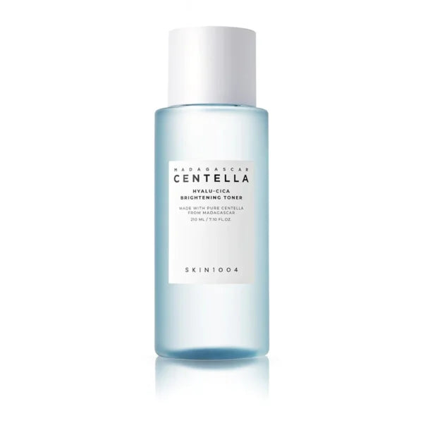 SKIN1004 Madagascar Centella Hyalu-Cica Brightening Toner featuring a light blue translucent body and a white cap, set against a plain white background with a soft reflection.