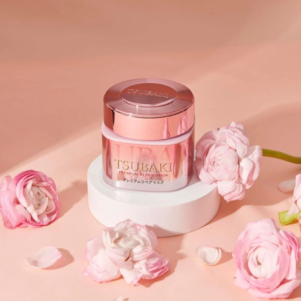 Tsubaki Premium Repair Hair Mask Pink Camellia with pink flowers on a soft pink background