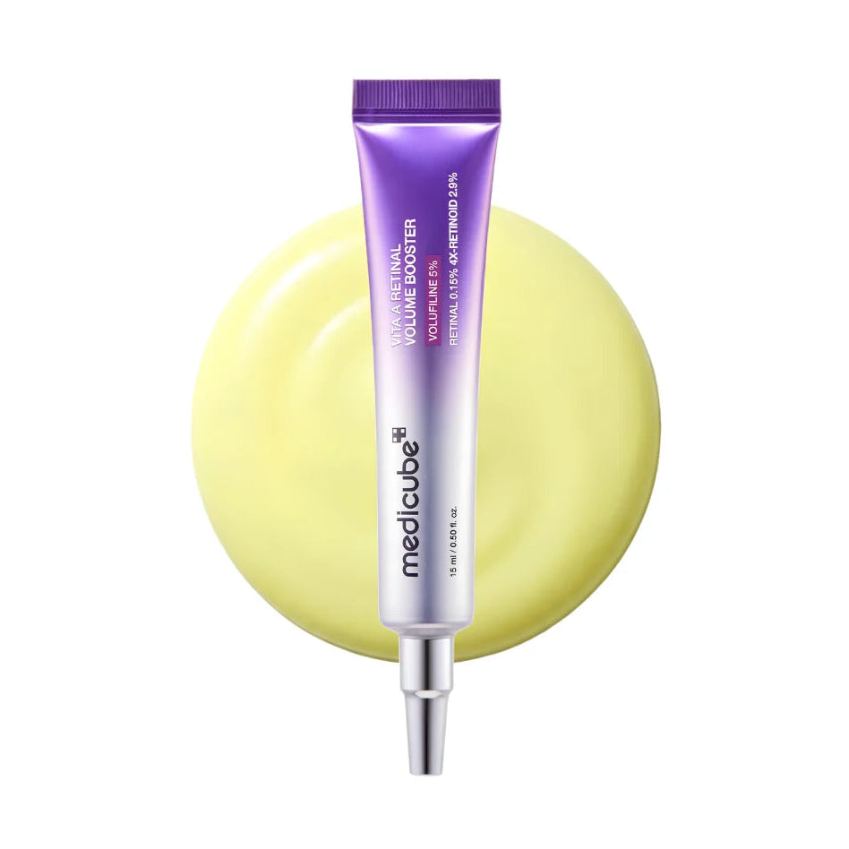 A Medicube Vita A Retinal Volume Booster tube with a purple-to-silver gradient and silver applicator tip, centered in front of a pale yellow circular backdrop on a white background.