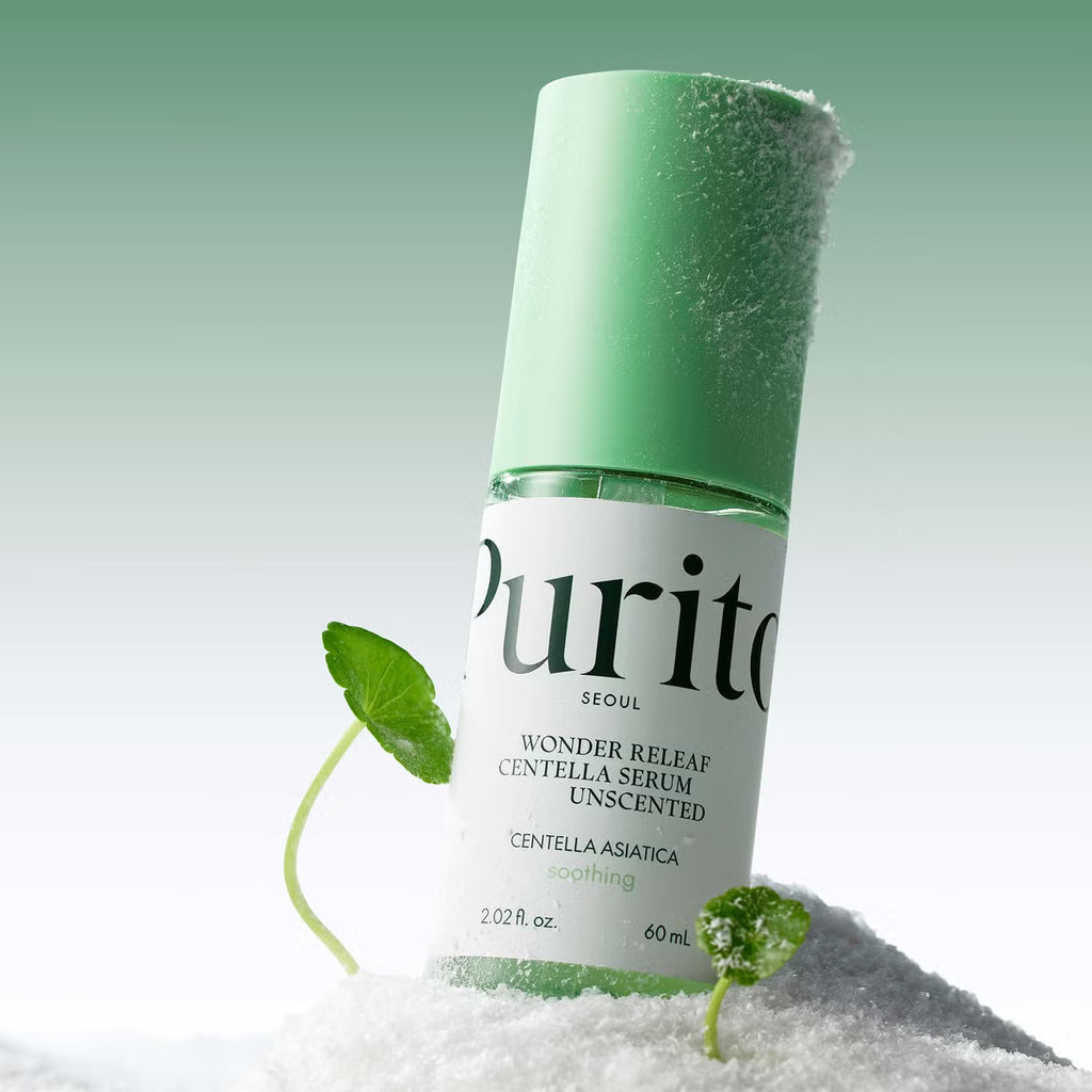 Purito Wonder Releaf Centella Unscented Serum bottle with green cap and leaves on a white background