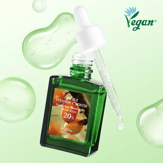 Green bottle of dr. althea vitamin C serum with dropper on a light green background, featuring the Vegan logo
