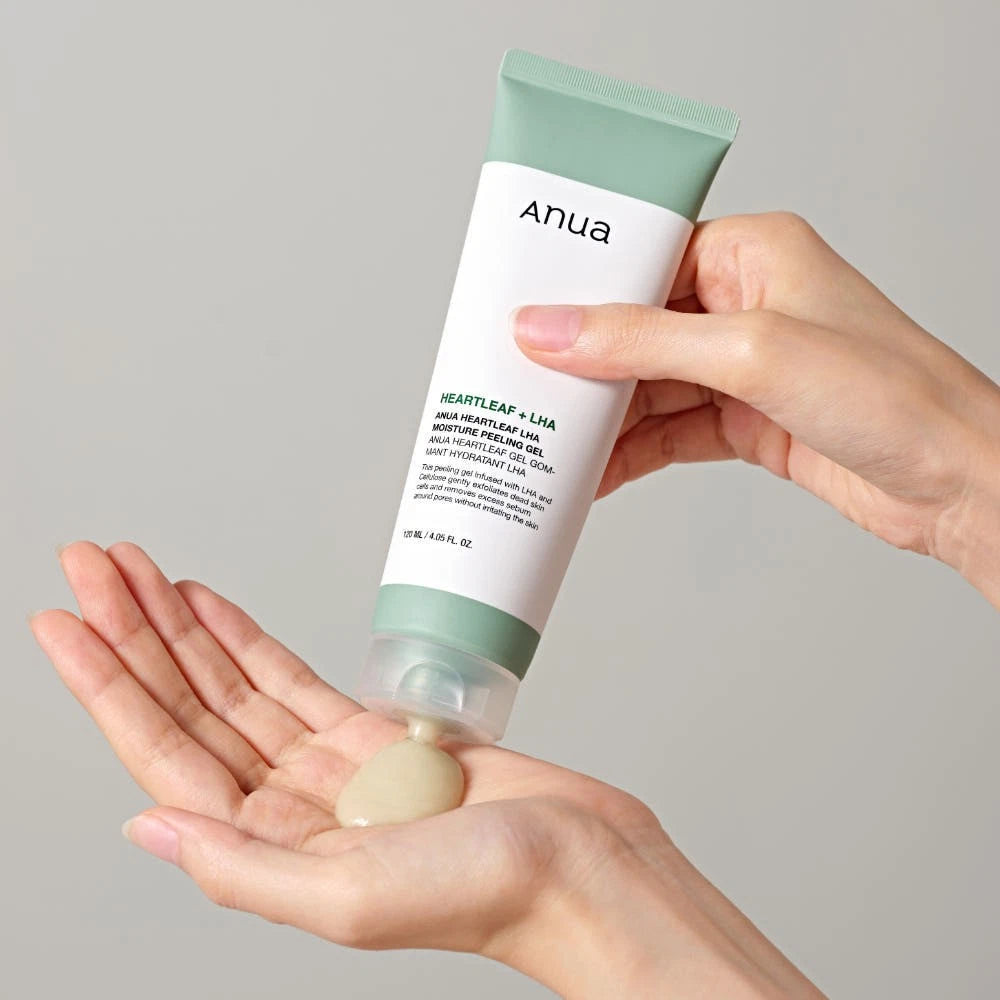 Hand holding a tube of Anua Heartleaf LHA Moisture Peeling Gel with a small amount on the palm against a neutral background